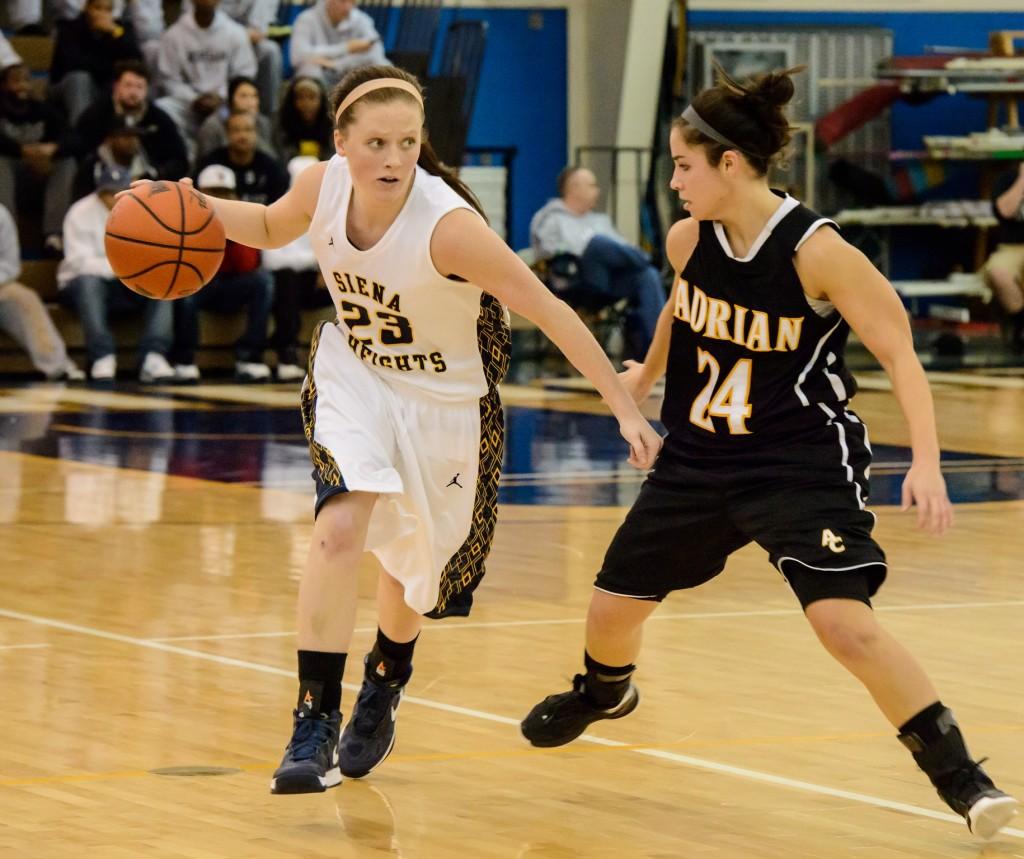 SHU junior Grace Howrigon keeps the ball away from Adrian Colleges Nicole Boggs (Photo Courtesy of SHU Marketing).