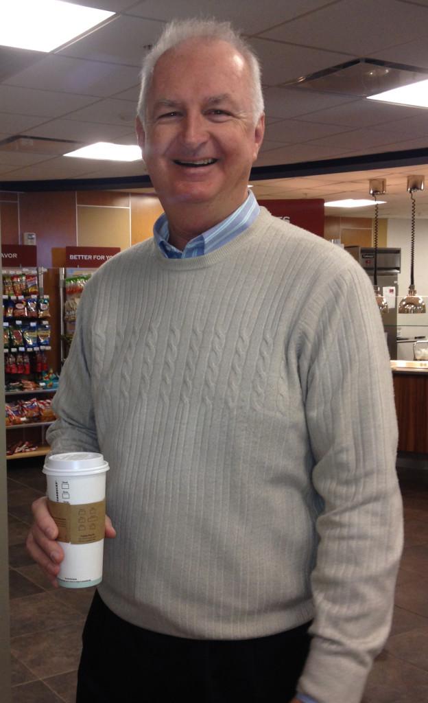 Father John socializing while grabbing a coffee at the SHU Shop.