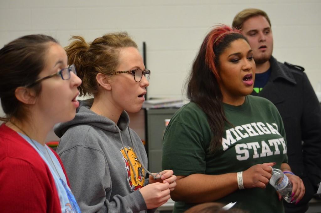 Missy Dojcsak, Jocelyn Near, Rolecia Looney and Aaron Shown sing their hearts out in Acapelicans practice. (Photo by Elise Hardcastle)