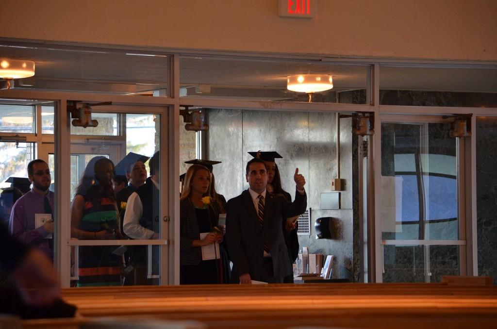Michael Orlando, dean of students, leads the class of 2014 into St. Dominics Chapel for the Torch Light ceremony.